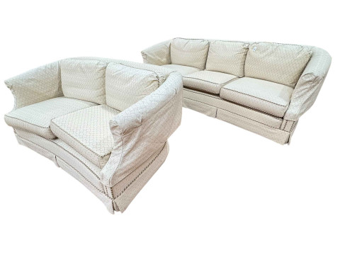 Three seater and two seater settees in cream geometric fabric, originally...