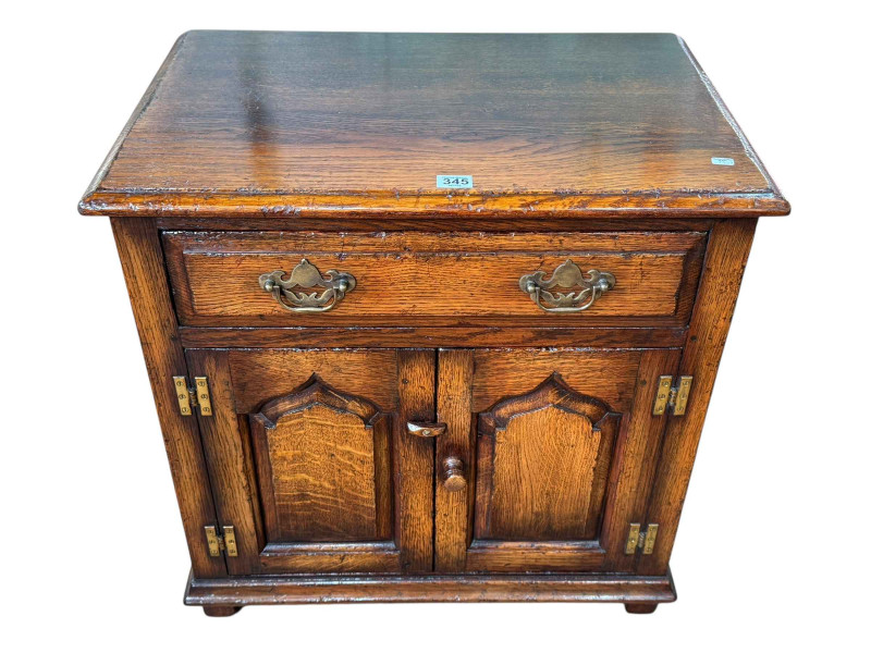 Titchmarsh & Goodwin oak cabinet having two arched fielded panel doors below a long drawer, 61cm by 61cm by 40.5cm.