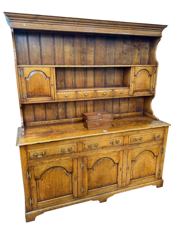 Good quality oak dresser possibly by Titchmarsh & Goodwin?, the shelf back having two small cupboard doors and four spice drawers above a base of three drawers with three arched fielded panel doors below, 191cm by 168cm by 48cm.