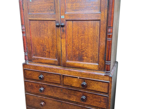 Victorian oak and mahogany linen press having two panelled cupboard doors...