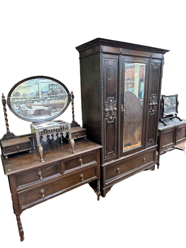 1920's oak Jacobean style four piece bedroom suite comprising mirror door wardrobe, dressing table, marble topped washstand and toilet mirror.