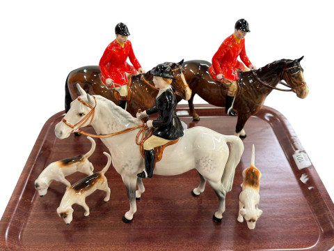 Two Beswick Huntsmen and Huntswoman on Horseback and three hounds.