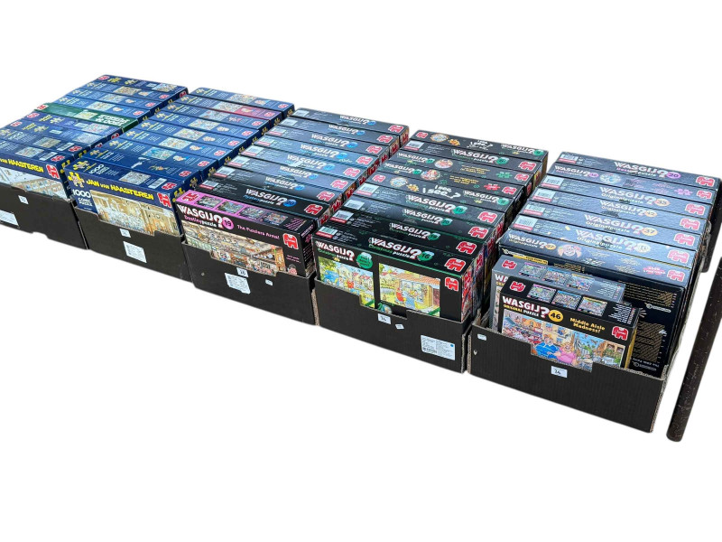 Three boxes of Wasgij puzzles, Original, Mystery and Christmas, and two boxes of Jan Van Haasteren comic jigsaw puzzles.