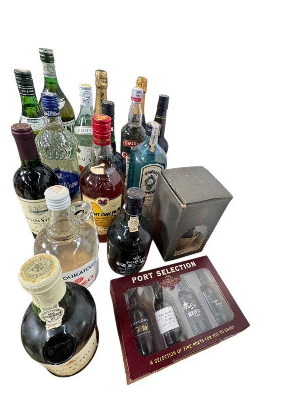 Assorted bottles of spirits including Martini, Cinzano, Bacardi, Smirnoff, Bombay Sapphire, Mount Gay Rum, etc.