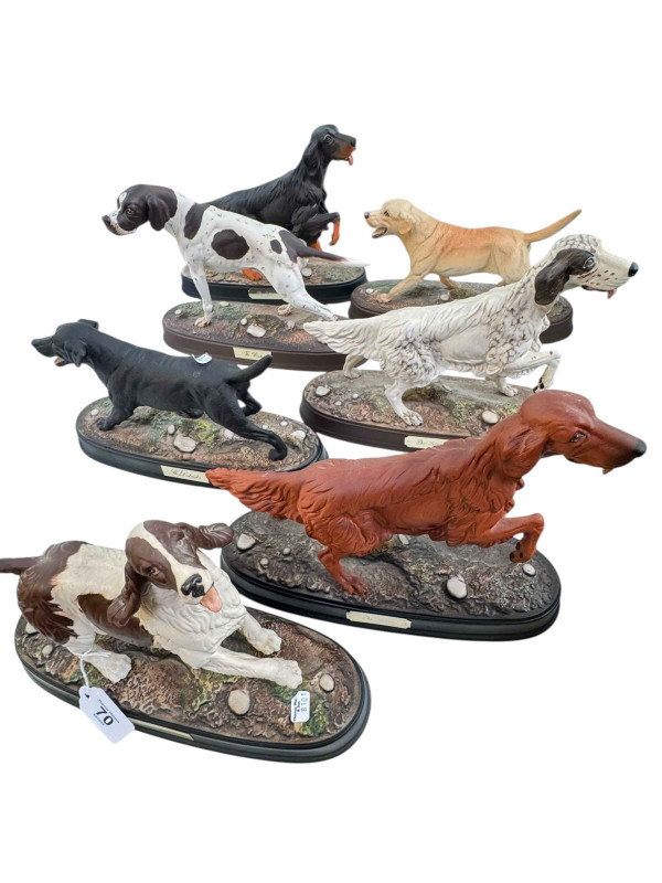 Seven Royal Doulton dogs on plinths, three Setters, two Labradors, Pointer and Spaniel.