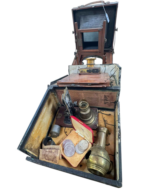 Vintage plate camera, three Churchill coins and three Bermuda crowns.