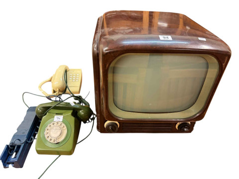 Vintage Bush Bakelite television and three telephones.