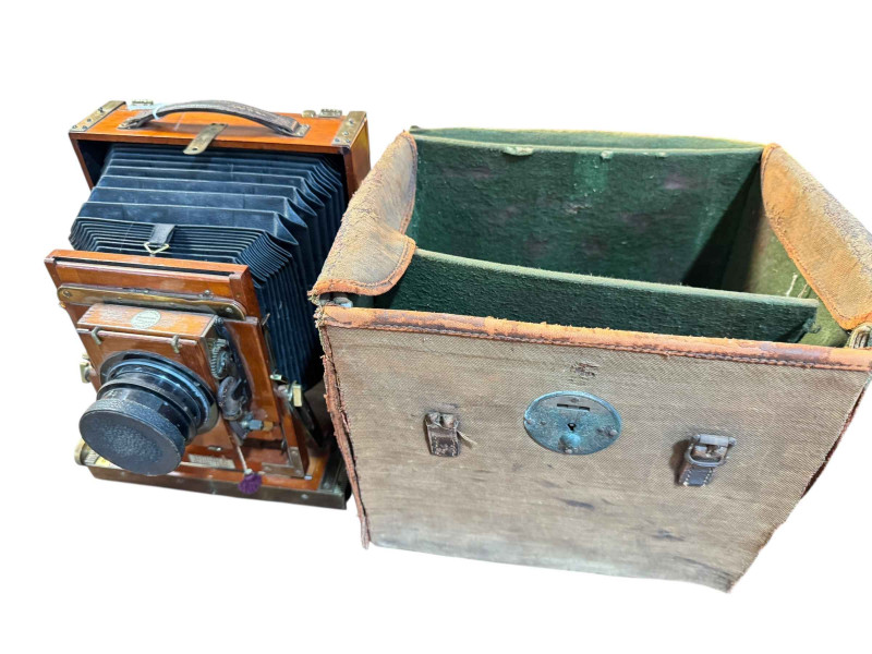 Late 19th/Early 20th Century Thornton Pickard mahogany and brass folding plate camera, number 406076, canvas bag and plates.
