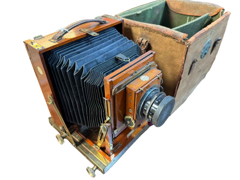 Late 19th/Early 20th Century Thornton Pickard mahogany and brass folding plate camera, number 406076, canvas bag and plates.