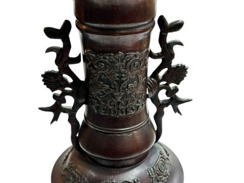 Large Japanese bronze vase with twin handles decorated in relief mythical creature and flower raised on three legs to circular base, 45.5cm. thumbnail
