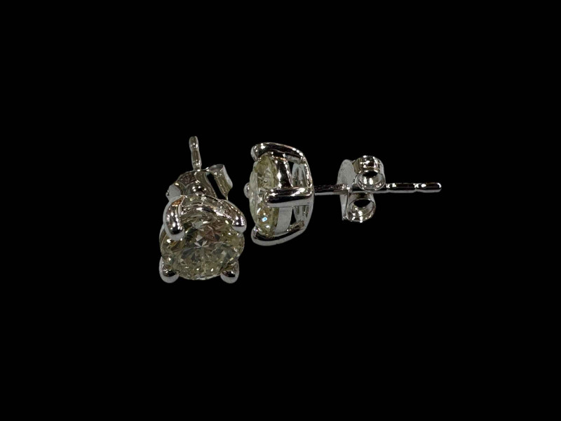 Pair of diamond stud earrings set in 18 carat white gold, diamonds totalling over 1 carat.
