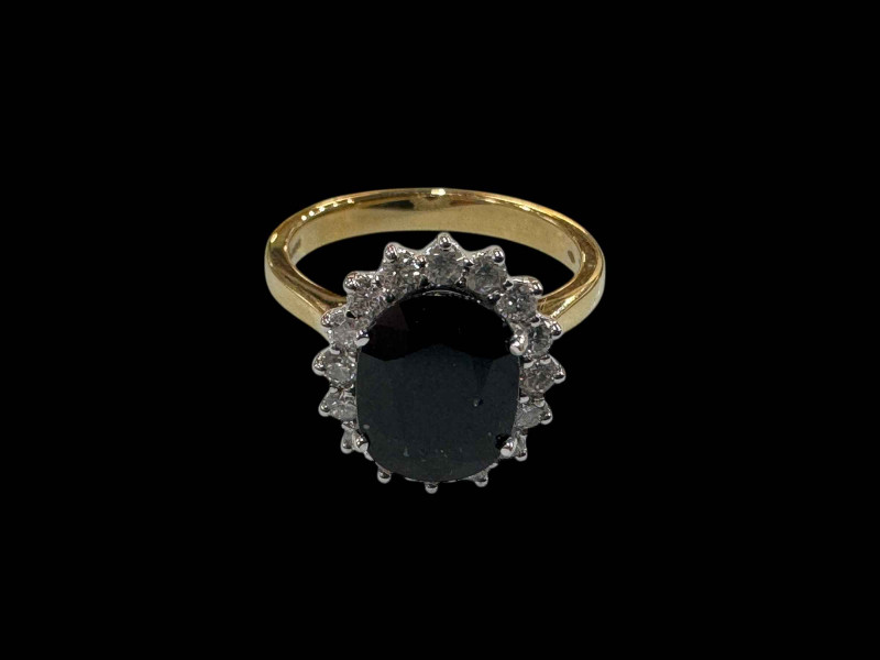18 carat white gold oval sapphire and diamond cluster ring, the oval sapphire totalling over 3.5 carats, size N.