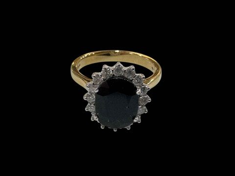 18 carat white gold oval sapphire and diamond cluster ring, the oval sapphire...