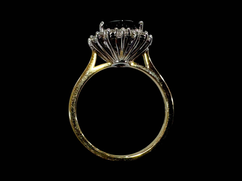 18 carat white gold oval sapphire and diamond cluster ring, the oval sapphire totalling over 3.5 carats, size N.