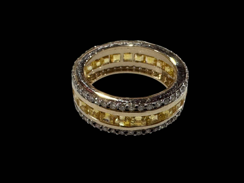 14 carat yellow sapphire and diamond eternity ring, the central band of sapphires 3.42 carats flanked by two rows of diamonds totalling 0.89 carats, size L.