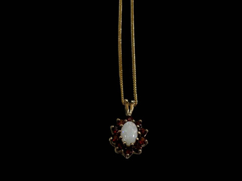 Opal and garnet pendant with 9 carat gold fine necklace.