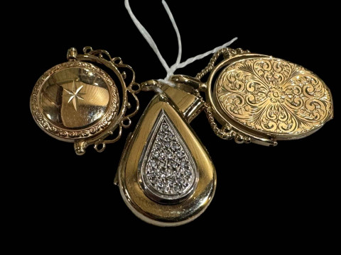 Two 9 carat gold locket pendants and another.