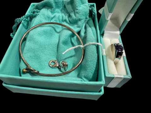 Tiffany silver and gold knot bangle, together with heart charm and silver...