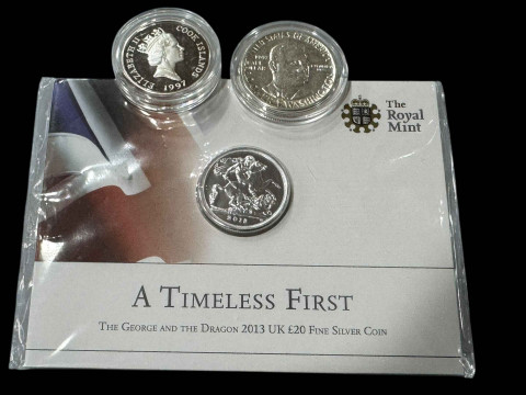 Three silver proof coins, £20 sovereign, Cook Islands 2 dollar and Booker...