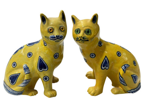 Two Gallé style pottery yellow cats, 21cm.