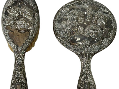 Embossed silver back brush and mirror set.