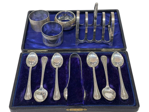 Cased set of silver teaspoons and tongs, three silver napkin rings and...