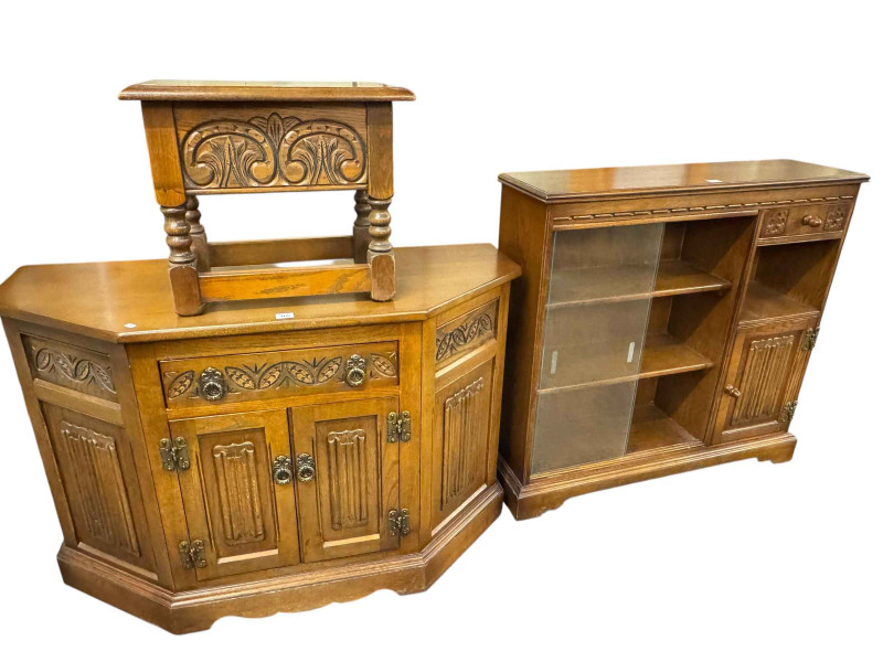 Four piece suite of Old Charm furniture comprising cabinet bookcase, 89cm by 93cm by 27cm, canted corner two door cabinet 71.5cm by 109.5cm by 43.5cm, box stool and wall mirror.