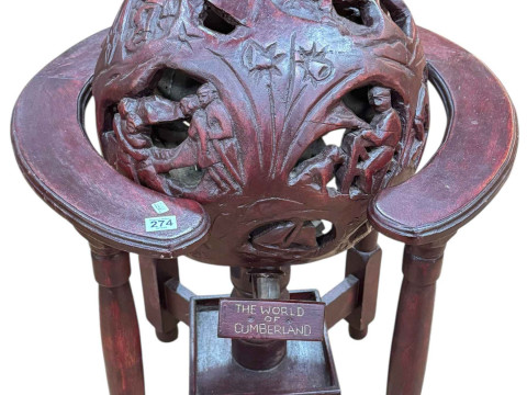 The World of Cumberland carved revolving globe on stand.