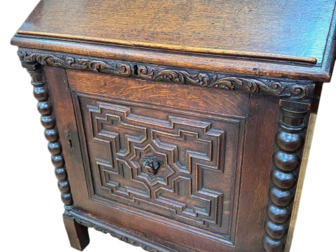 19th Century carved oak desk, the slope top front enclosing eight drawers...
