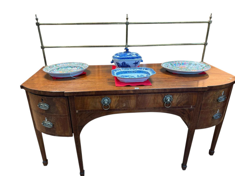 George III mahogany breakfront sideboard having brass rail back and on six square tapering legs to spade feet, 143cm by 183cm by 73cm.