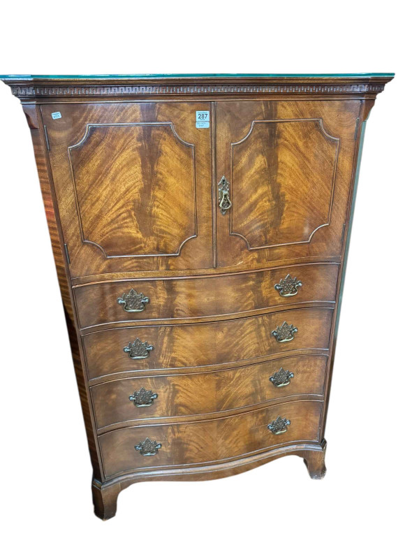 Waring & Gillow mahogany serpentine front linen chest having two doors above four long drawers with canted corners and on bracket feet, 139cm by 90cm by 53cm.
