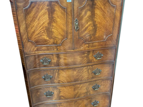 Waring & Gillow mahogany serpentine front linen chest having two doors...