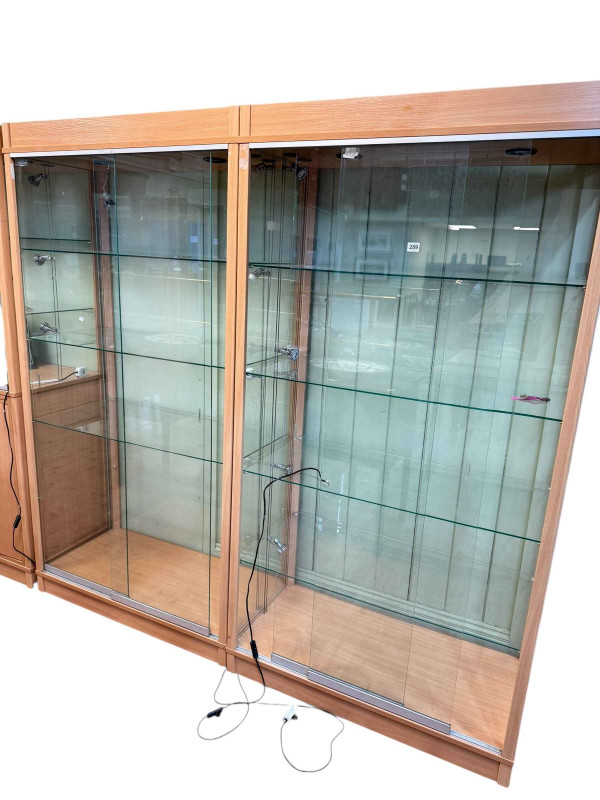 Pair beech finish sliding glazed door illuminated shop display cabinets, 191cm by 99.5cm by 49.5cm (lacking one shelf).