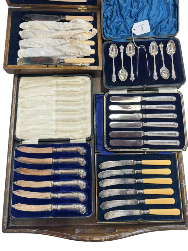 Set of six silver spoons and tongs, pistol grip and other silver handled knives, set of knives and set of fish eaters.