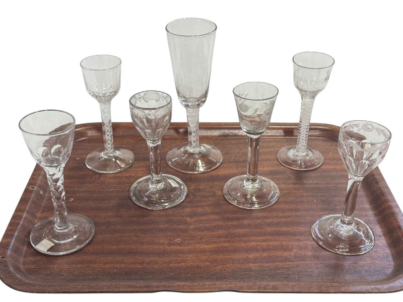 Seven antique drinking glasses including opaque twist wine glasses.