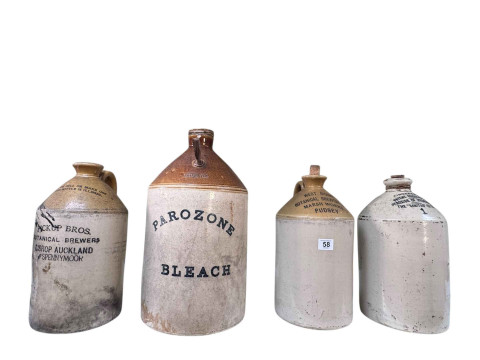 Four large stoneware bottles including Pickup Bros Botanical Brewers,...