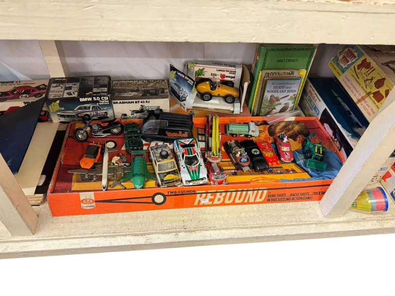 Two Beswick pigeons, antique Magneto electric machine, stamp album, toy cars and vintage games.