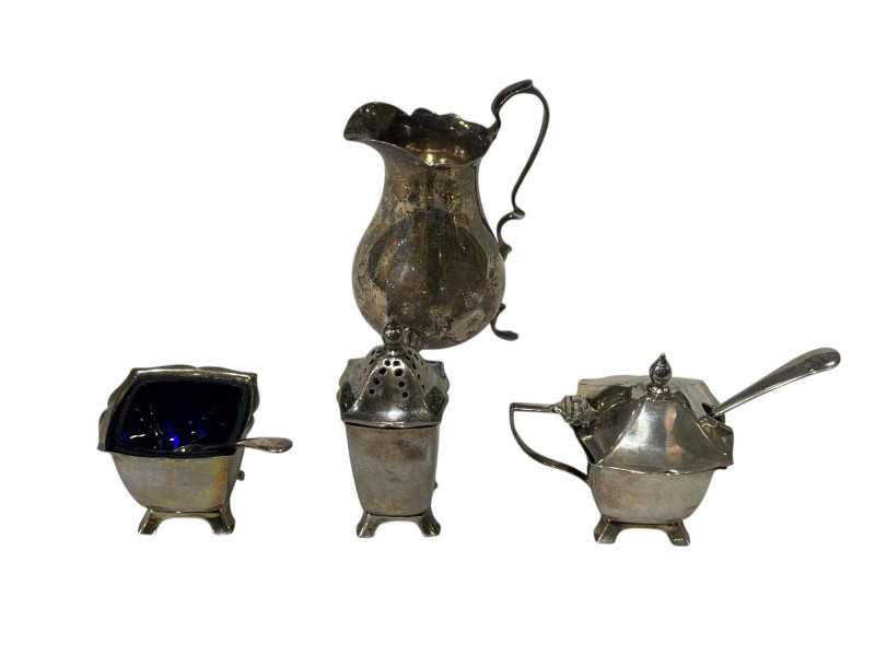 Silver cream jug and three-piece cruet.