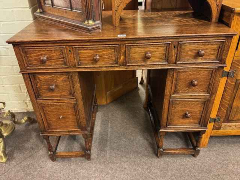 Oak six-drawer kneehole desk and oak three-door shelf back dresser (2).