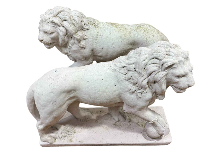 Pair garden lions standing with a ball at their feet.