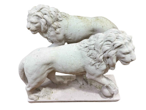 Pair garden lions standing with a ball at their feet.