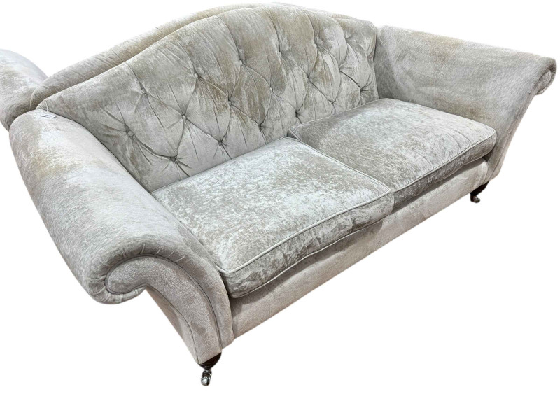 Pair Laura Ashley button back sofas in light plush fabric.