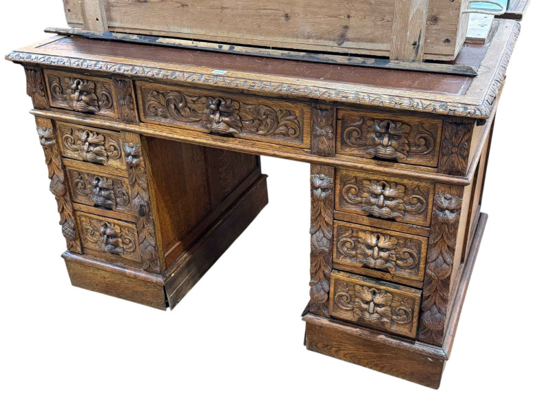 Victorian oak lion mask carved nine-drawer pedestal desk, 76 x 122 x 76cm.