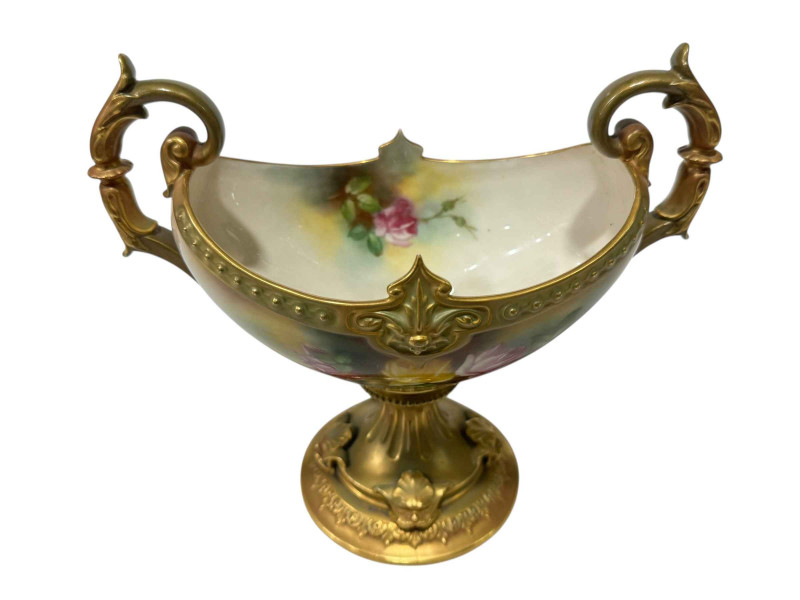 Royal Worcester two-handled tazza painted with roses by M Blake with green/gilt base, 18cm.