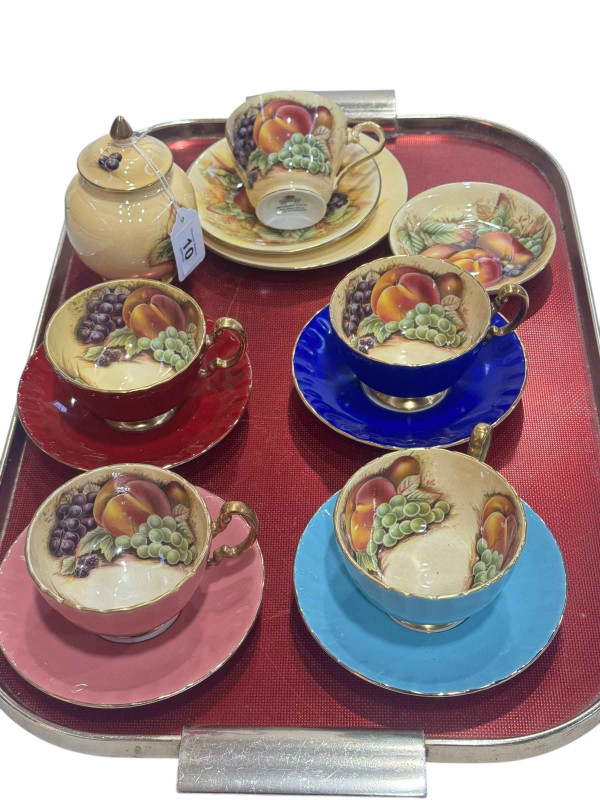 Four Aynsley cabinet cups and saucers with fruit decoration and five pieces of Orchard Gold including trio.