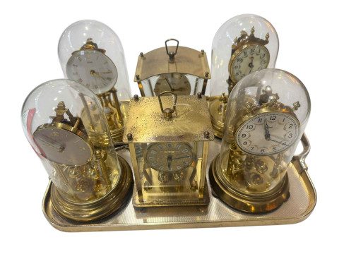 Six German anniversary clocks, four under domes.