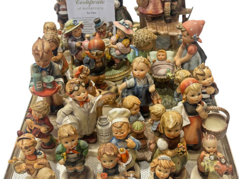 Collection of twenty four Hummel figures and groups, two with certificates.
