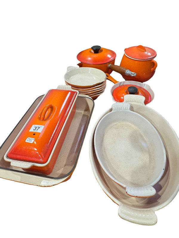 Collection of Le Creuset pans and dishes and six tier pan stand.