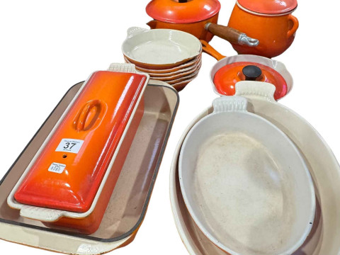 Collection of Le Creuset pans and dishes and six tier pan stand.