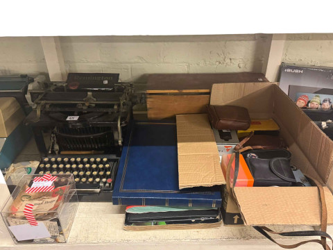 Full shelf of china, glass, silver plate, cameras, vintage typewriters, wood bowls, sewing machine, etc. thumbnail